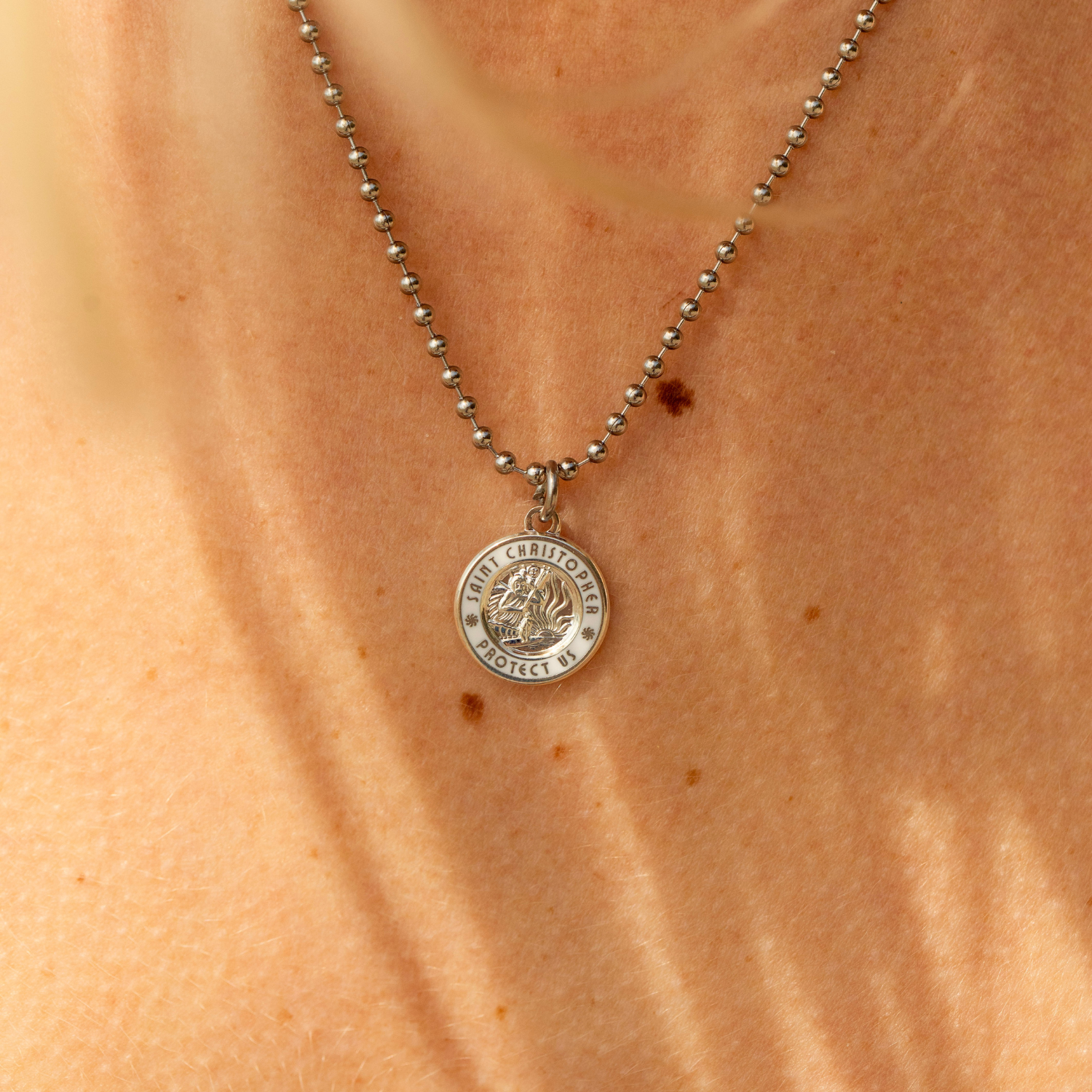 small silver white St. Christopher close up