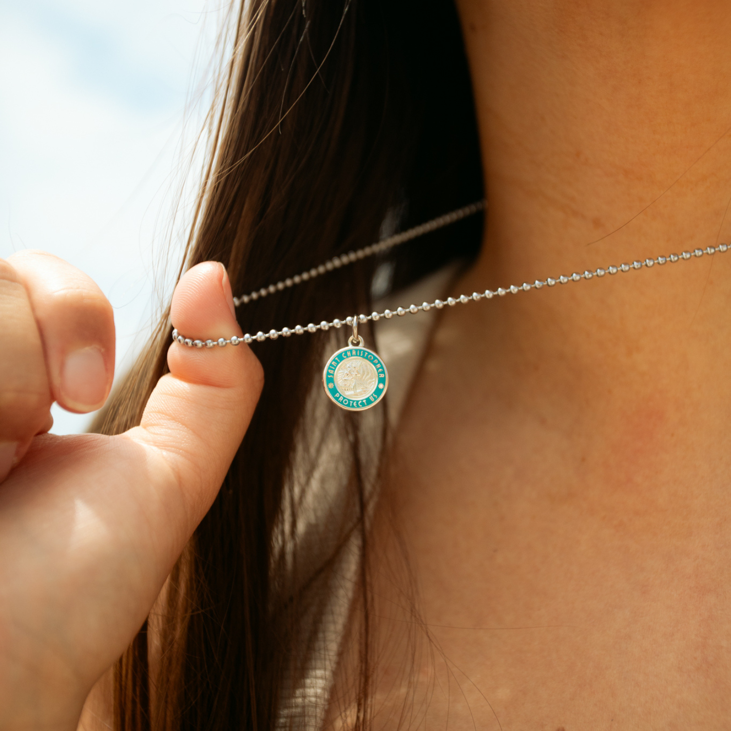 small silver baby blue st. christopher close up