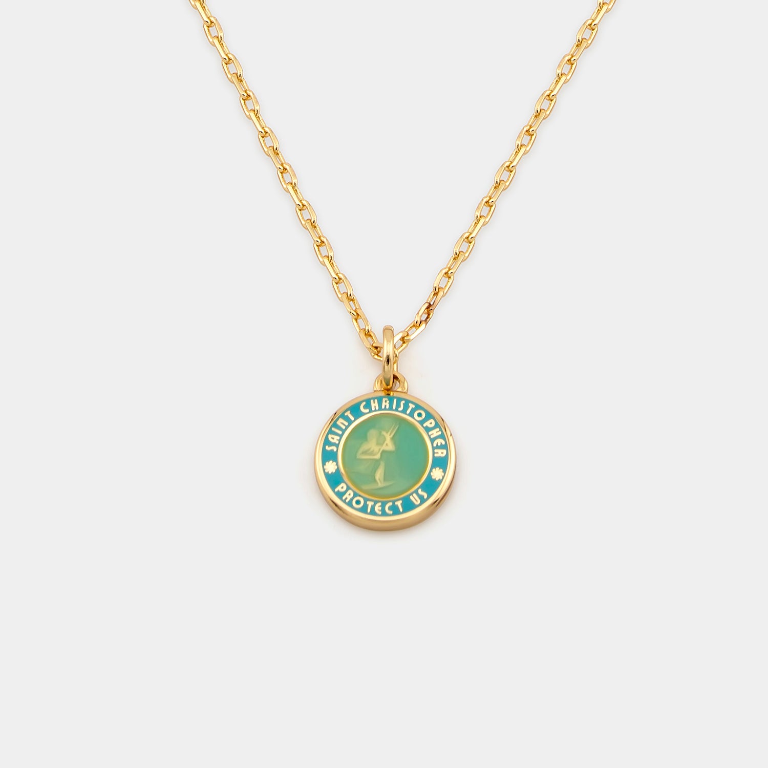 Gold necklace with a green pendant on a white background