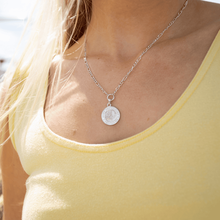Silver St. Christopher Medallion on figaro chain worn by Model with yellow shirt